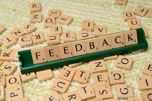 pexels-photo-18512803-18512803 Wooden letter tiles spelling 'feedback' on a green rack, representing communication and evaluation.